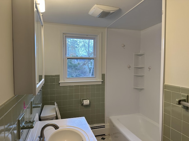 bathroom with visible vents, baseboard heating, vanity, and tile walls