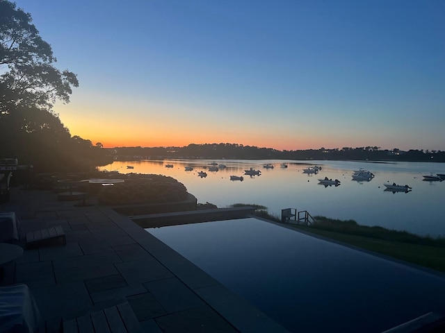 view of pool featuring a water view