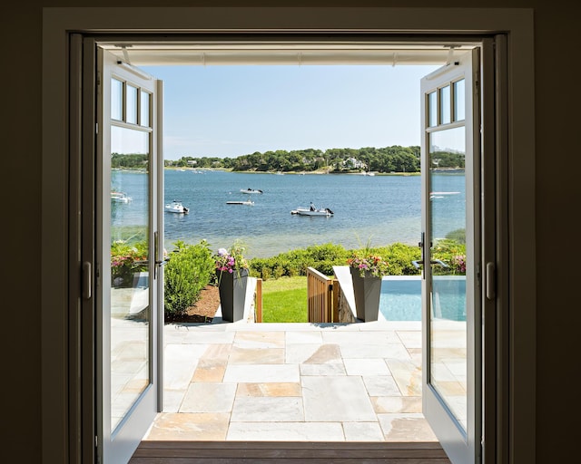 doorway to outside featuring a water view