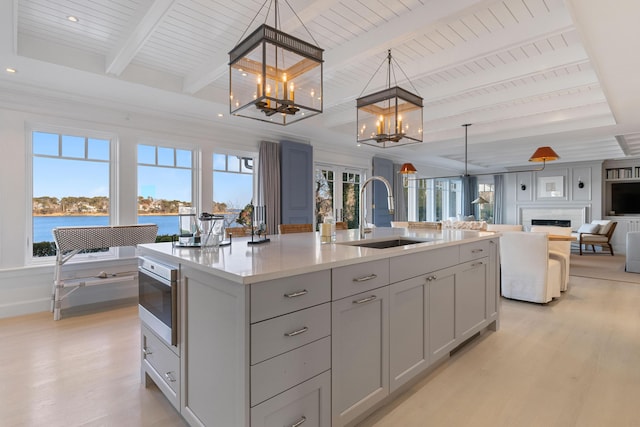 kitchen featuring a wealth of natural light, a sink, and oven