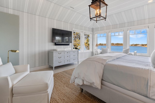 bedroom featuring visible vents and an inviting chandelier