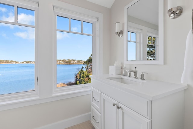 bathroom featuring plenty of natural light, a water view, and vanity