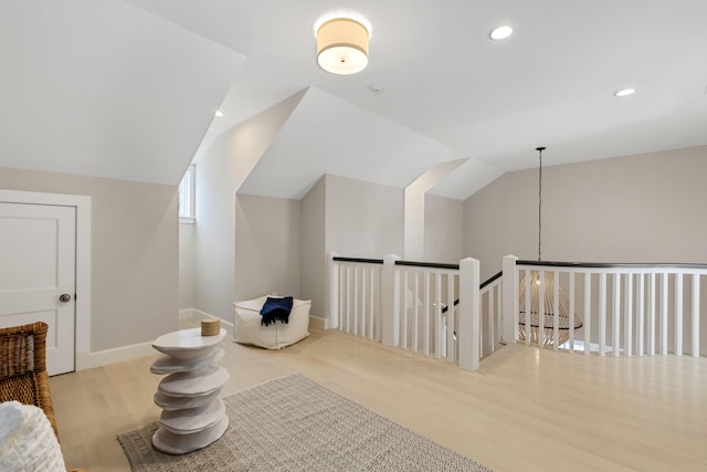 additional living space with lofted ceiling, baseboards, recessed lighting, and wood finished floors