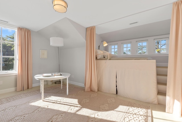 bathroom featuring vaulted ceiling, visible vents, and baseboards