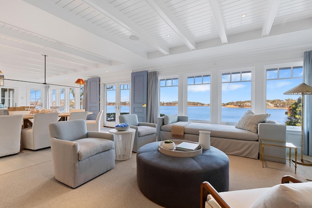 living room with recessed lighting, beam ceiling, and a water view