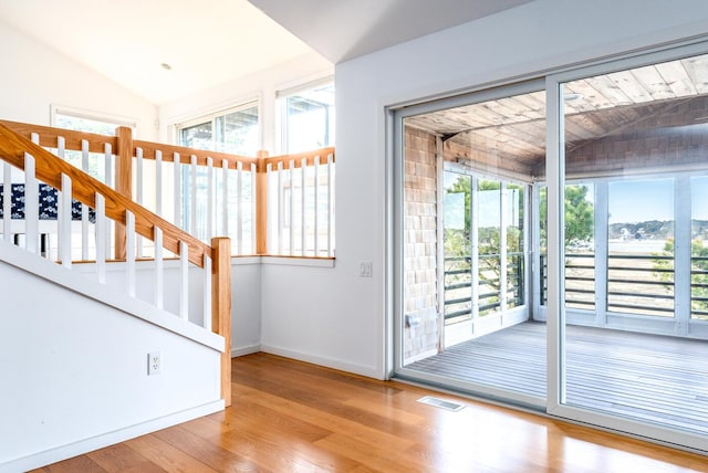 entryway featuring light hardwood / wood-style floors and vaulted ceiling