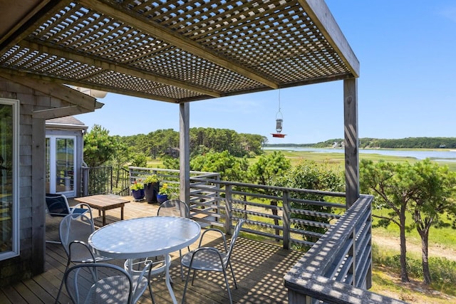 wooden terrace with a water view and a pergola