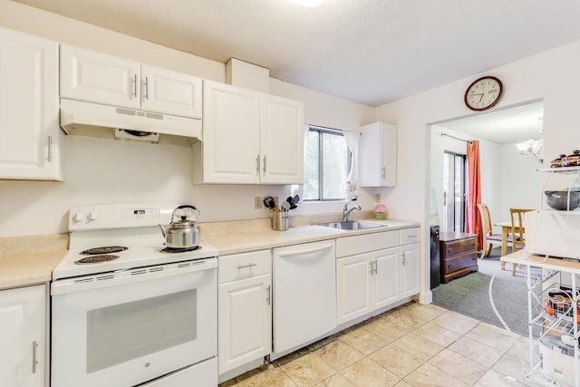 kitchen featuring sink, white cabinetry, light tile patterned floors, white appliances, and a textured ceiling