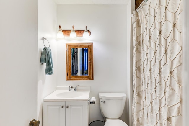 bathroom featuring vanity, toilet, and a shower with shower curtain