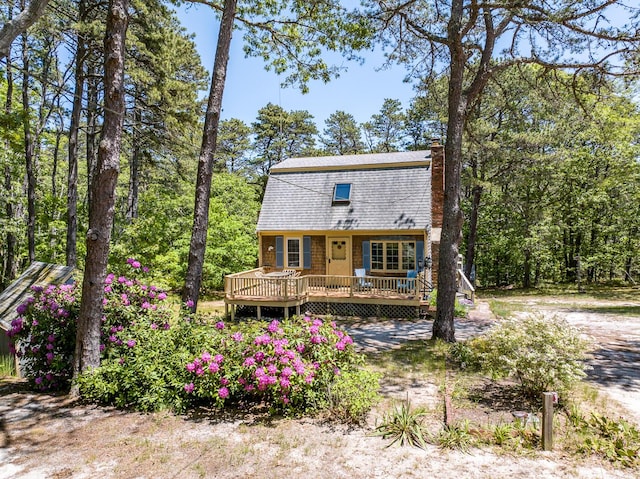 40 Georges Way, Wellfleet, MA 02667 - view of front of home featuring a deck, a gambrel roof, a chimney, and roof with shingles