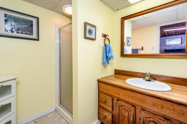 40 Georges Way, Wellfleet, MA 02667 - bathroom featuring a stall shower, vanity, tile patterned flooring, baseboards, and a paneled ceiling