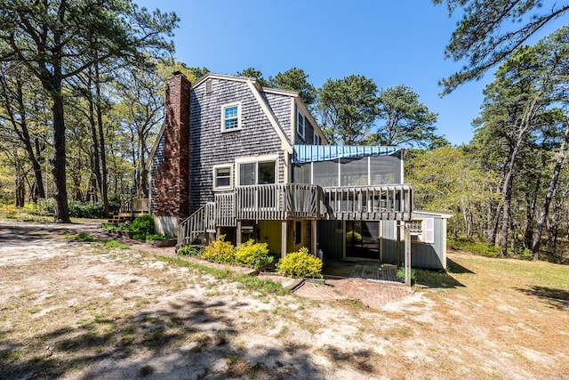 40 Georges Way, Wellfleet, MA 02667 - rear view of property with a sunroom, a wooden deck, a chimney, and a gambrel roof