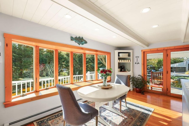 dining space with hardwood / wood-style flooring, a baseboard heating unit, and beam ceiling