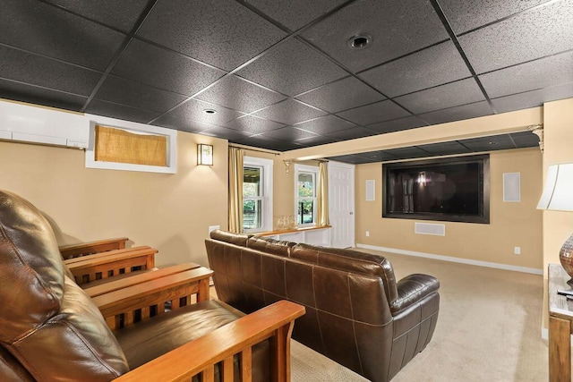 carpeted home theater featuring a drop ceiling and a wall unit AC