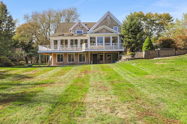 view of front of home featuring a wooden deck and a front yard