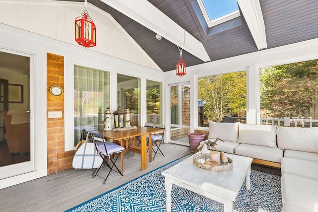 sunroom featuring plenty of natural light, vaulted ceiling with skylight, and wooden ceiling