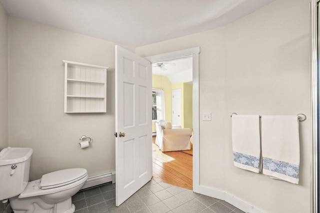 bathroom featuring a baseboard radiator, tile patterned floors, and toilet