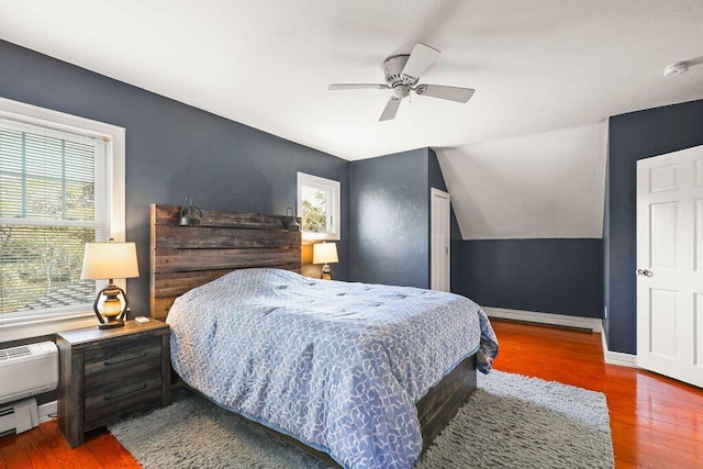 bedroom featuring ceiling fan, wood-type flooring, and lofted ceiling