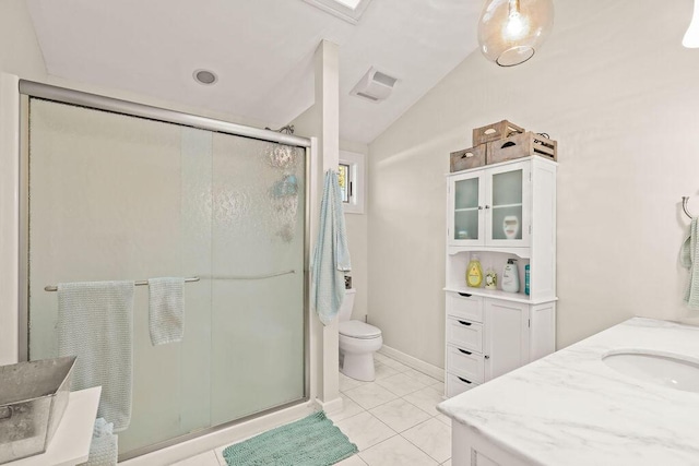 bathroom with vaulted ceiling, a shower with shower door, tile patterned flooring, vanity, and toilet