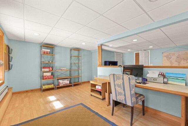 home office featuring wood-type flooring and built in desk