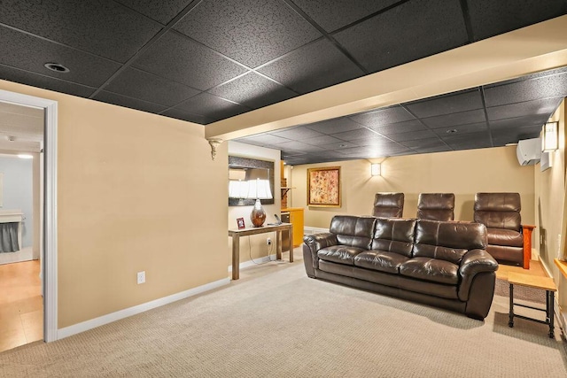 living room with carpet floors, a wall mounted air conditioner, and a drop ceiling