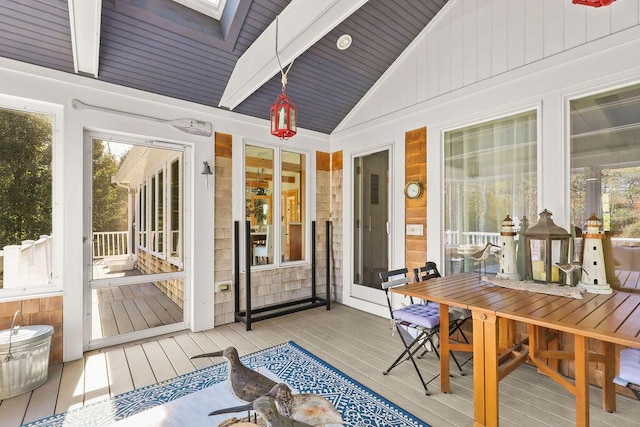 sunroom / solarium with wooden ceiling and vaulted ceiling with skylight