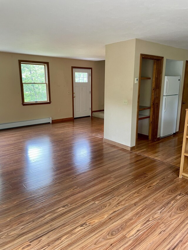 12 Park Ave, Vineyard Haven, MA 02568 - empty room featuring a baseboard heating unit, wood finished floors, and baseboards