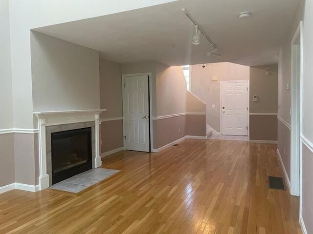12 Red Cedar Rd, Mashpee, MA 02649 - unfurnished living room with wood finished floors, rail lighting, a fireplace, and baseboards