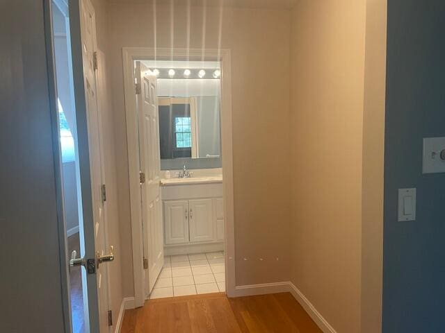 12 Red Cedar Rd, Mashpee, MA 02649 - hallway with baseboards, light wood-style floors, and a sink