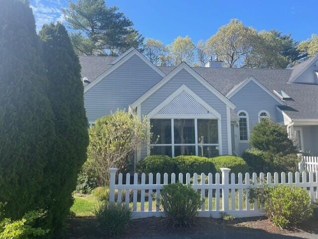 12 Red Cedar Rd, Mashpee, MA 02649 - view of property exterior with a sunroom and roof with shingles