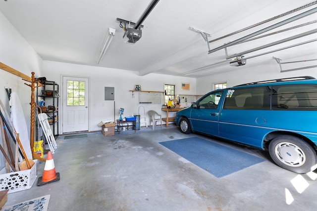 garage with a garage door opener and electric panel