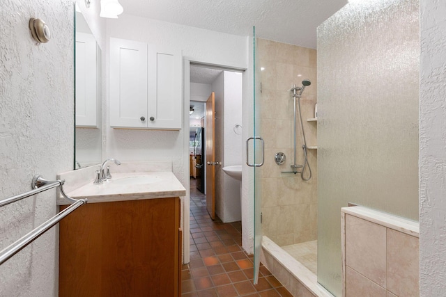 24 Sparrowhawk Rd, Orleans, MA 02653 - bathroom with a shower stall, vanity, tile patterned flooring, a textured wall, and a textured ceiling