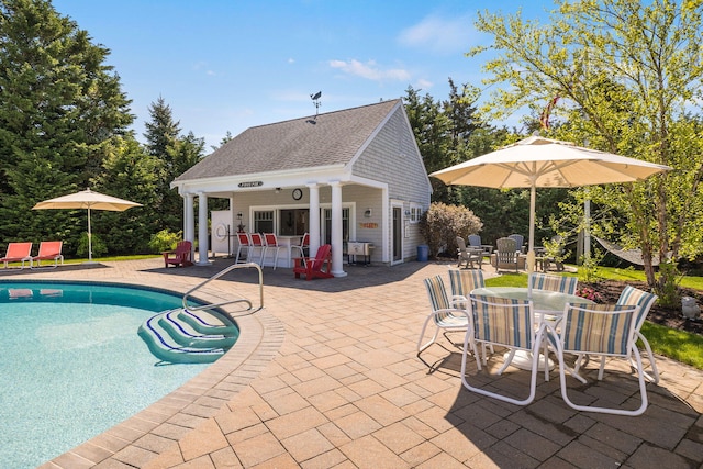10 Shiverick Rd, East Dennis, MA 02641 - swimming pool with an exterior structure, a patio, an outbuilding, and outdoor dining space