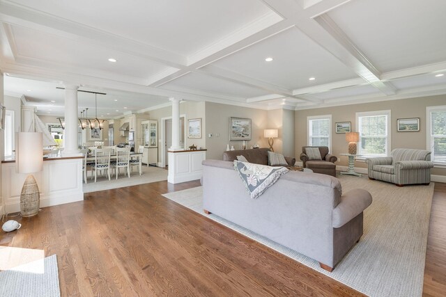 10 Shiverick Rd, East Dennis, MA 02641 - living room with decorative columns, wood finished floors, beam ceiling, coffered ceiling, and ornamental molding