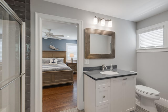 10 Shiverick Rd, East Dennis, MA 02641 - ensuite bathroom featuring vanity, ceiling fan, wood finished floors, and a tile shower