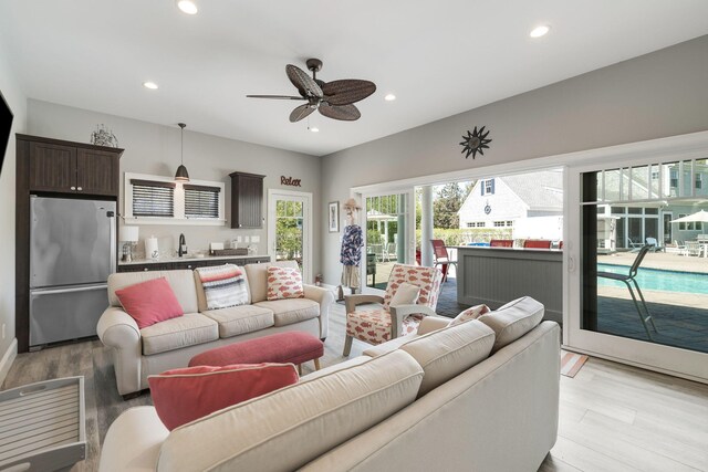 10 Shiverick Rd, East Dennis, MA 02641 - living area featuring light wood-type flooring, ceiling fan, recessed lighting, and bar