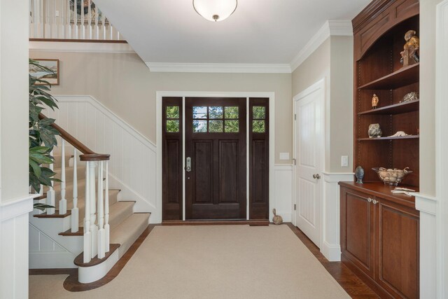10 Shiverick Rd, East Dennis, MA 02641 - foyer with a decorative wall, stairway, wainscoting, and ornamental molding