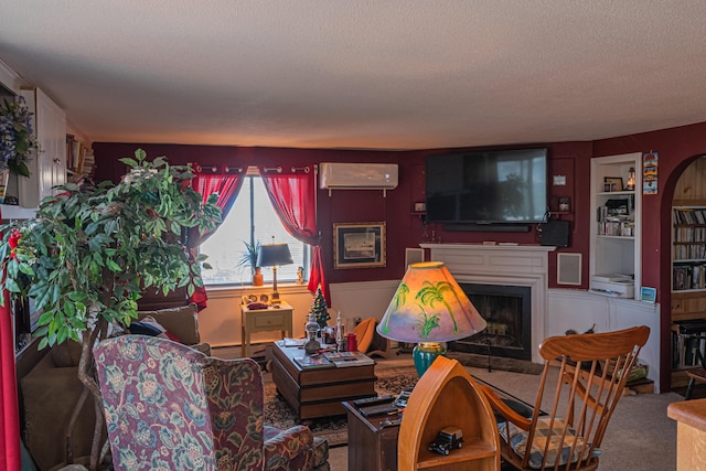 carpeted living room with built in shelves, baseboard heating, a textured ceiling, and a wall unit AC