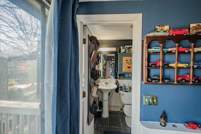 bathroom featuring toilet and tile patterned flooring