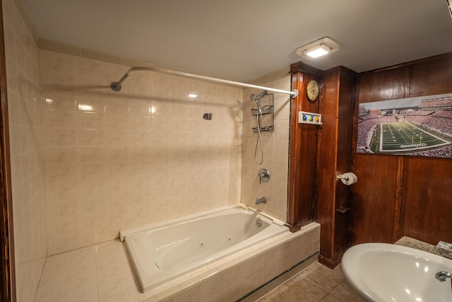 bathroom featuring sink, tiled shower / bath, and tile patterned flooring