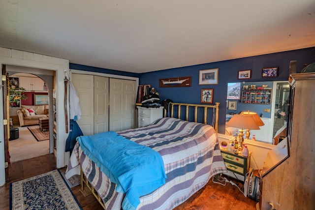 bedroom with hardwood / wood-style flooring and a closet