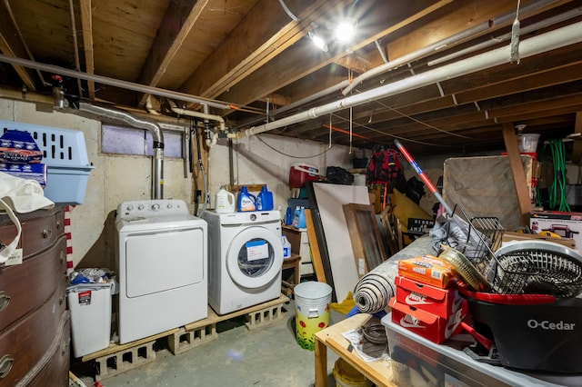 basement with washing machine and dryer and water heater