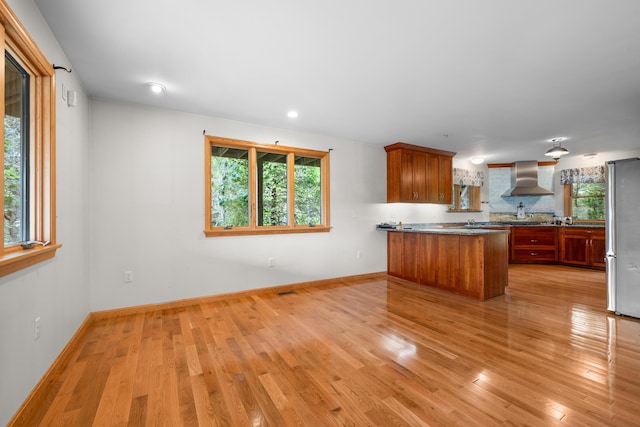 9 Priest Rd, Truro, MA 02666 - kitchen with freestanding refrigerator, wall chimney exhaust hood, a peninsula, light wood-style floors, and recessed lighting