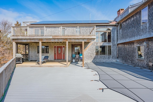 9 Priest Rd, Truro, MA 02666 - back of property featuring roof mounted solar panels and a wooden deck