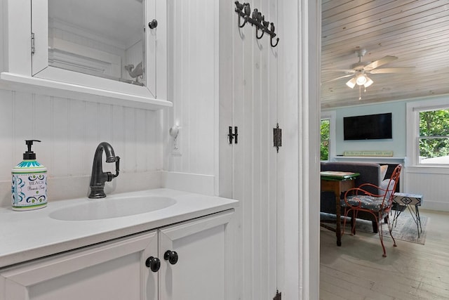 1205 Massasoit Rd, Eastham, MA 02642 - bathroom featuring vanity, ceiling fan, and wood finished floors