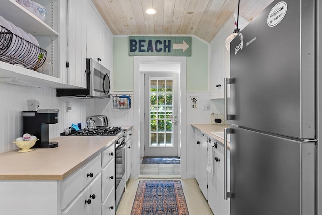 1205 Massasoit Rd, Eastham, MA 02642 - kitchen with stainless steel appliances, wooden ceiling, white cabinetry, open shelves, and light countertops