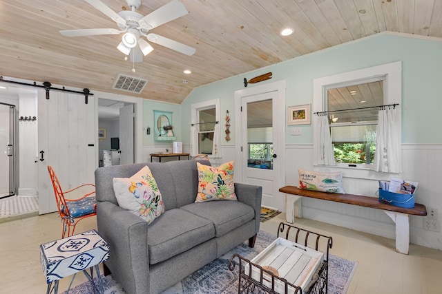 1205 Massasoit Rd, Eastham, MA 02642 - living area featuring wood ceiling, vaulted ceiling, wainscoting, a barn door, and recessed lighting