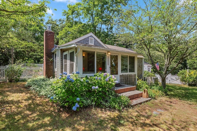1205 Massasoit Rd, Eastham, MA 02642 - view of front of property with a chimney and a sunroom