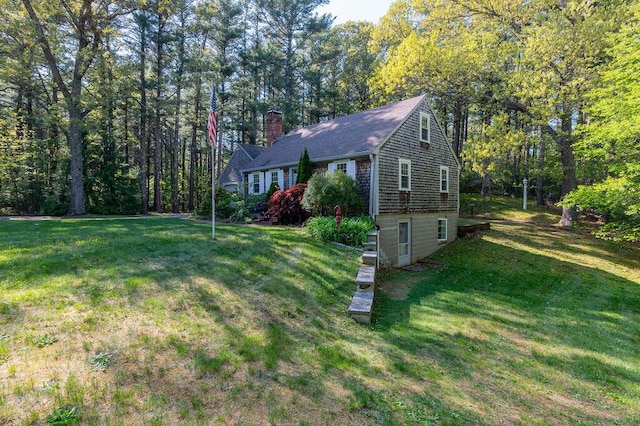 188 Church St, Duxbury, MA 02332 - view of front of house with a chimney, a front yard, and roof with shingles