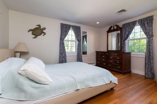 188 Church St, Duxbury, MA 02332 - bedroom with hardwood / wood-style floors, multiple windows, baseboards, and a baseboard radiator